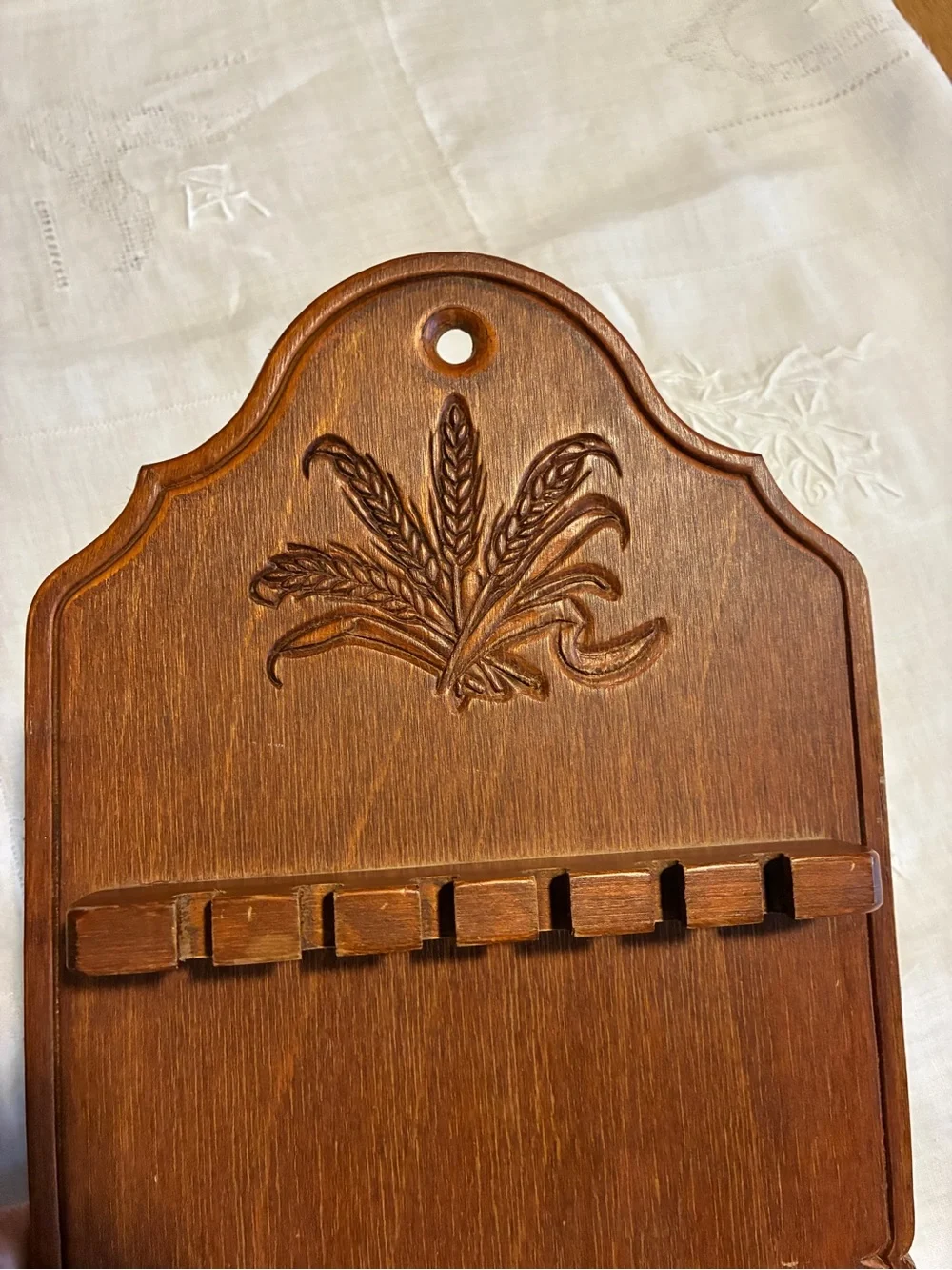 Vintage wood spoon holder with wheat design at the too.